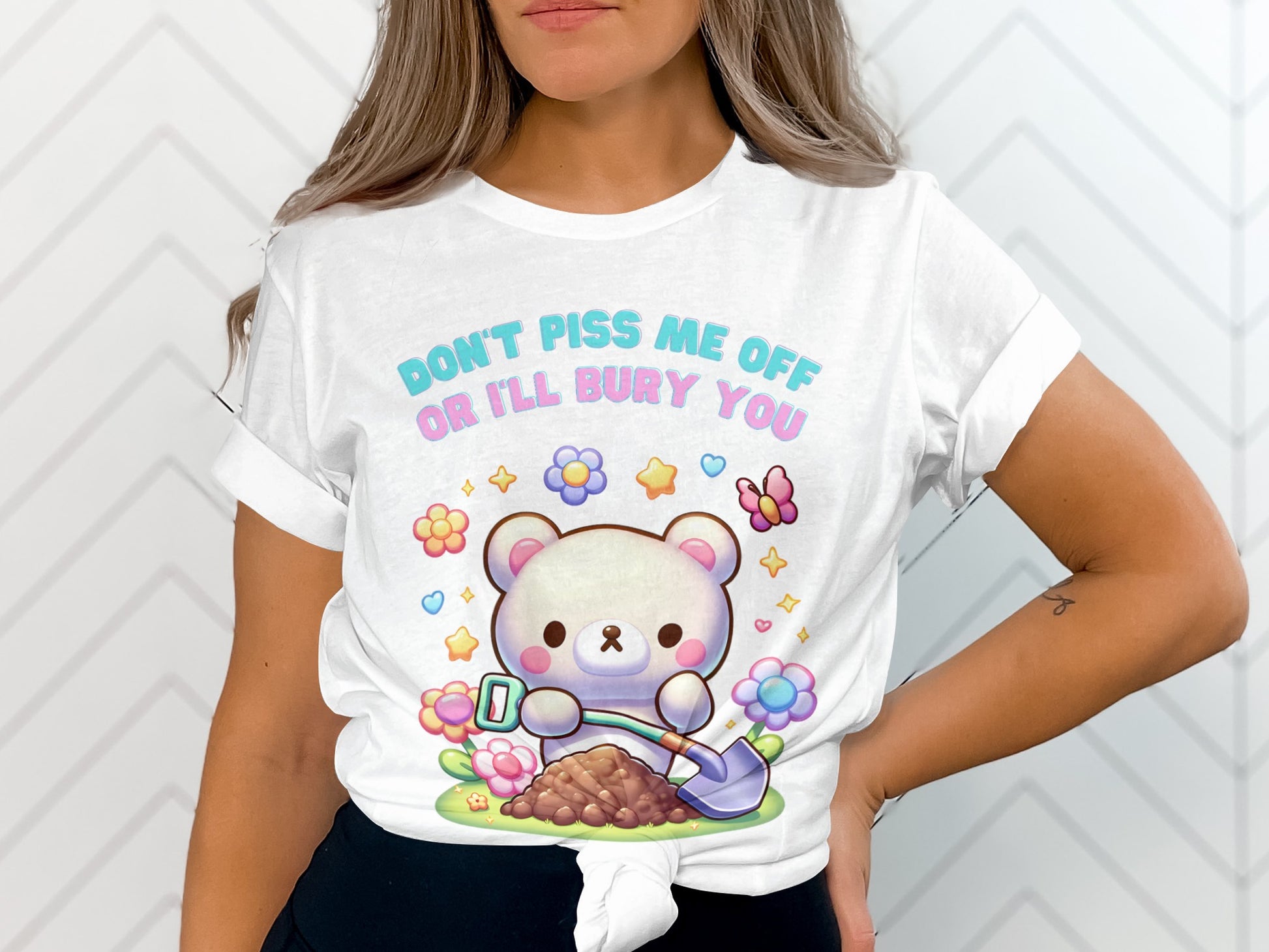 White t-shirt with a kawaii bear digging dirt, surrounded by flowers and stars.