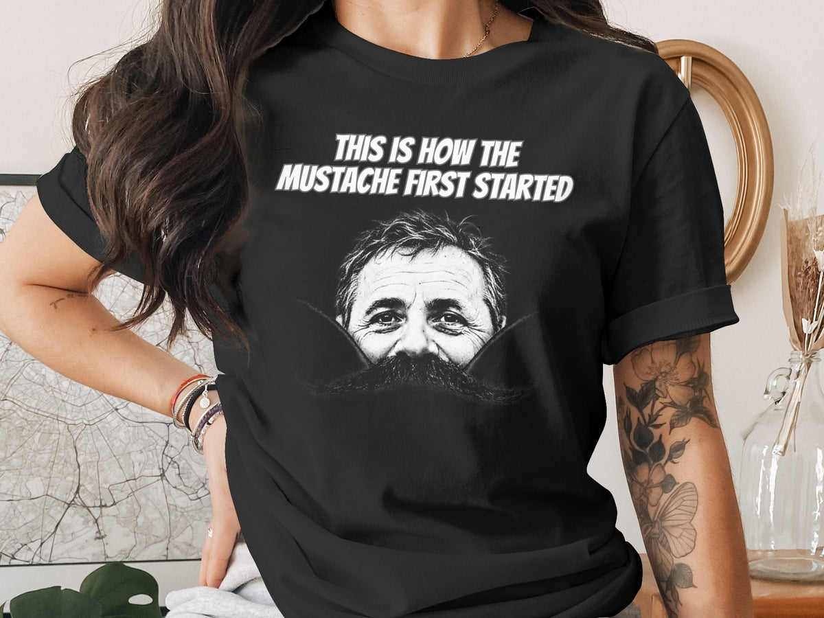 Black t-shirt with text "This is how the mustache first started" and a man's face with mustache.