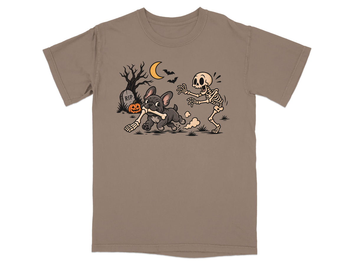 T-shirt graphic of French Bulldog stealing bone from skeleton with tombstone and pumpkin.