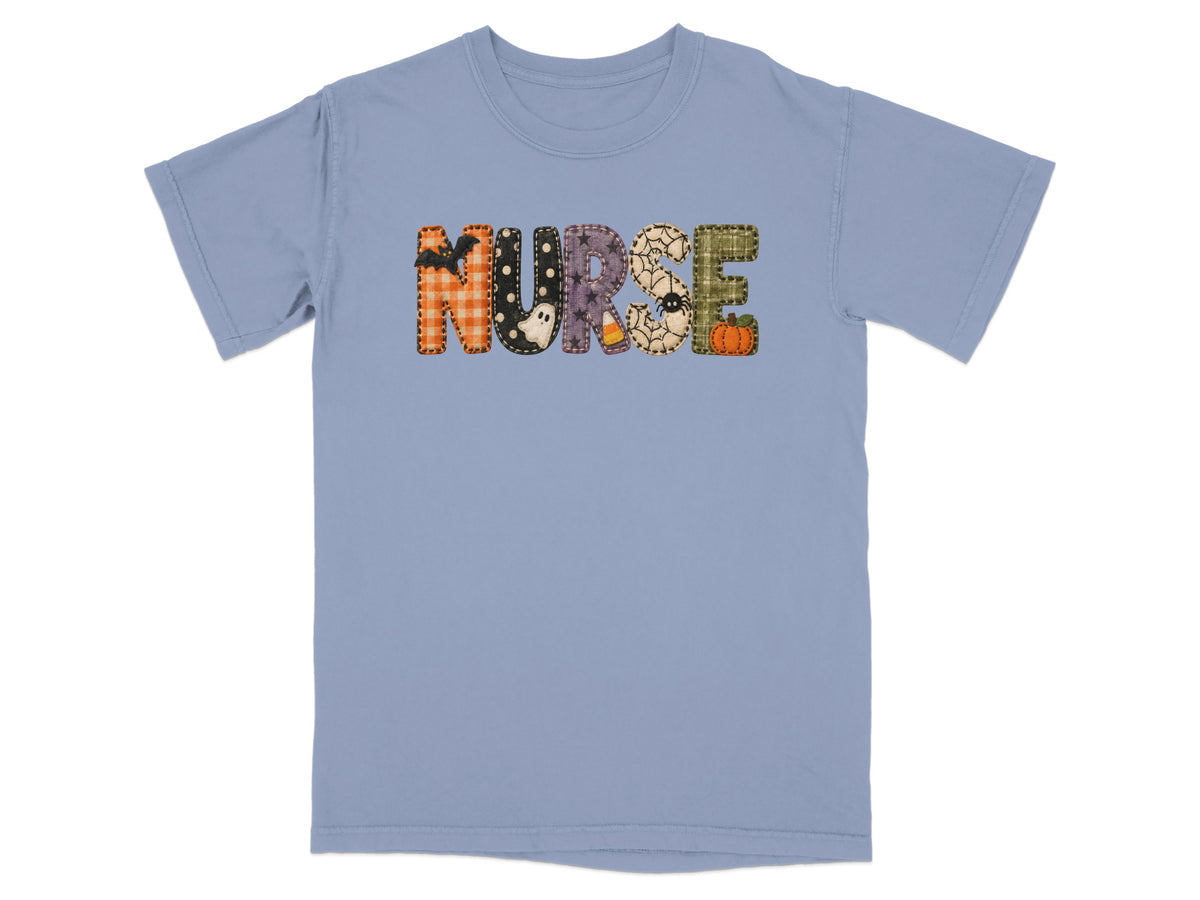 Blue t-shirt with "NURSE" spelled out in Halloween-themed patchwork letters.