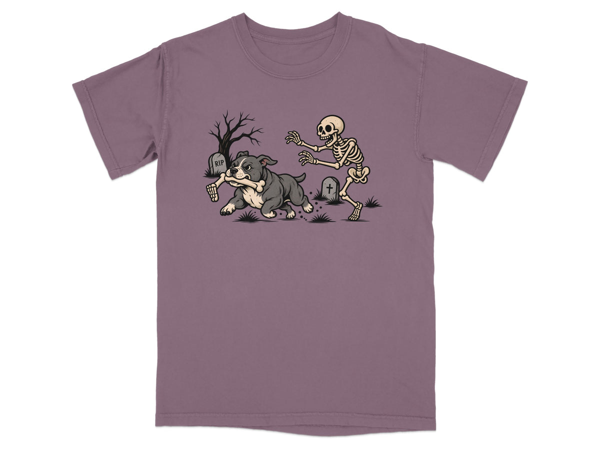 A purple t-shirt featuring a graphic of a bulldog running away with a skeleton's arm.