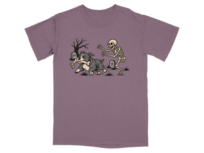 A purple t-shirt featuring a graphic of a bulldog running away with a skeleton's arm.
