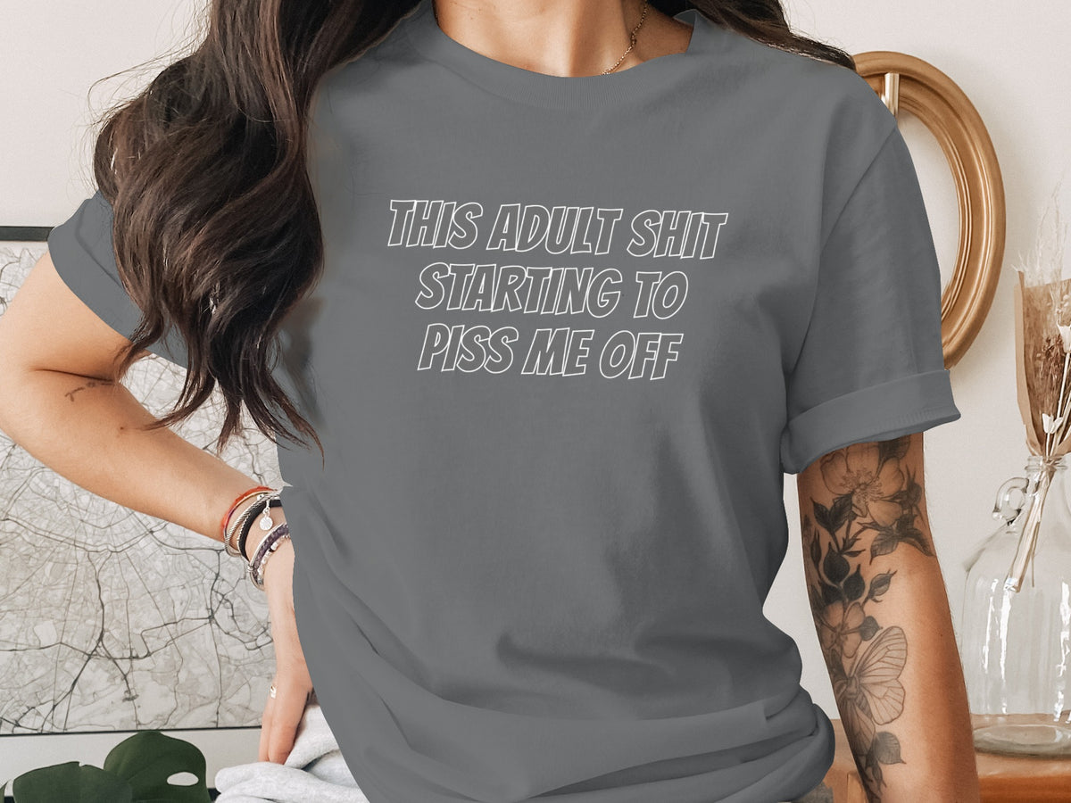 Grey t-shirt with white text "THIS ADULT SHIT STARTING TO PISS ME OFF".