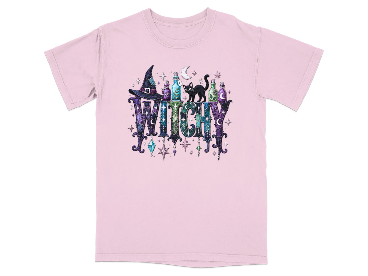 Pink t-shirt with "WITCHY" text, witch hat, potion bottles, and black cat.