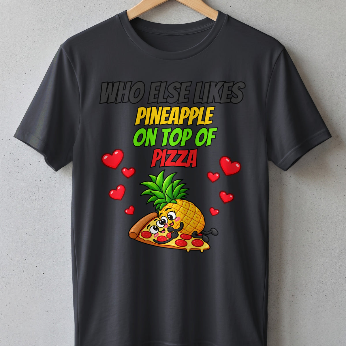 Dark t-shirt with text "Who else likes pineapple on top of pizza" and cartoon pineapple on pizza.