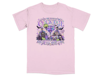 Pink t-shirt with Halloween cocktail illustration and text "Pour the Boos in the Cocktail and Sip All Night Long".
