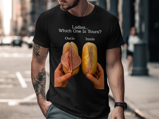Black t-shirt with text "Ladies.... Which One Is Yours? Outie Innie" and two hotdog buns with deli meat.