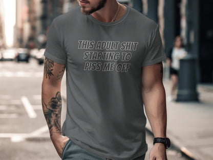 Grey t-shirt with white text "THIS ADULT SHIT STARTING TO PISS ME OFF".