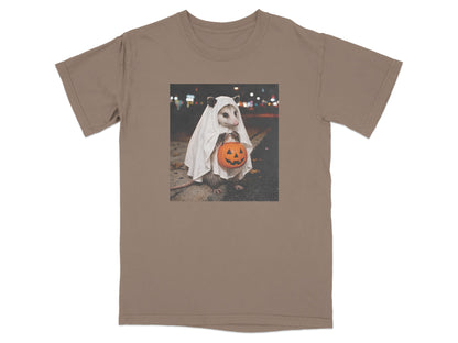 Opossum in ghost costume holding a jack-o-lantern bucket at night.
