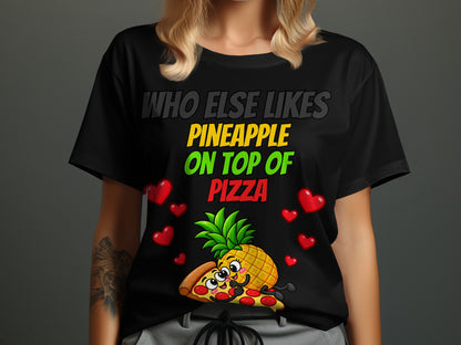Black t-shirt with text "Who Else Likes Pineapple On Top Of Pizza" and cartoon.