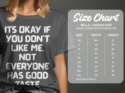 Gray t-shirt with white text "It's okay if you don't like me. Not everyone has good taste." and size chart.