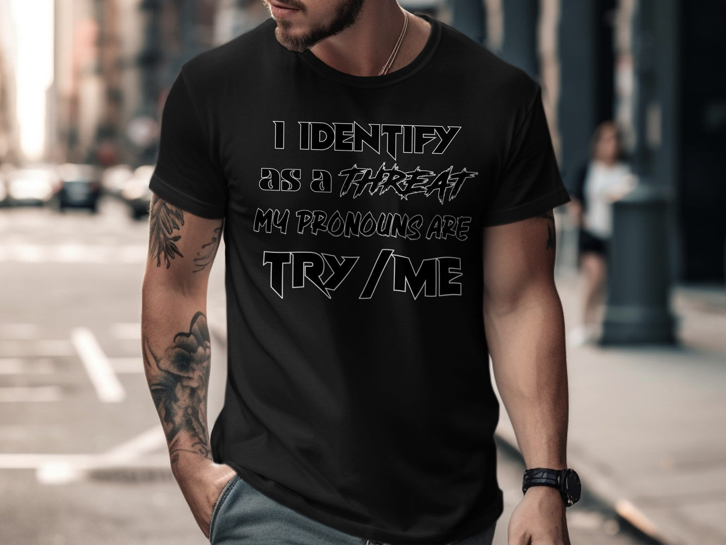 Black t-shirt with white text saying "I IDENTIFY AS A THREAT MY PRONOUNS ARE TRY ME".