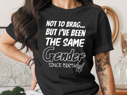 Black t-shirt with white text: "Not to brag... but I've been the same Gender Since Birth" and rock hand gesture.