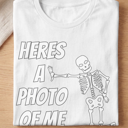 White t-shirt with skeleton and text "HERES A PHOTO OF ME".