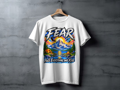 White t-shirt with graphic text "FEAR" and mountain landscape with tent and text "FACE EVERYTHING AND RISE".