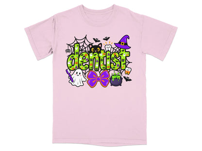 A light pink t-shirt featuring a green Halloween-themed graphic with the word dentist.