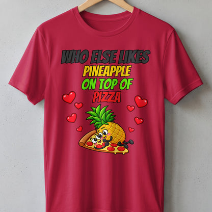 Red t-shirt with cartoon pineapple on pizza and text "Who Else Likes Pineapple On Top Of Pizza".