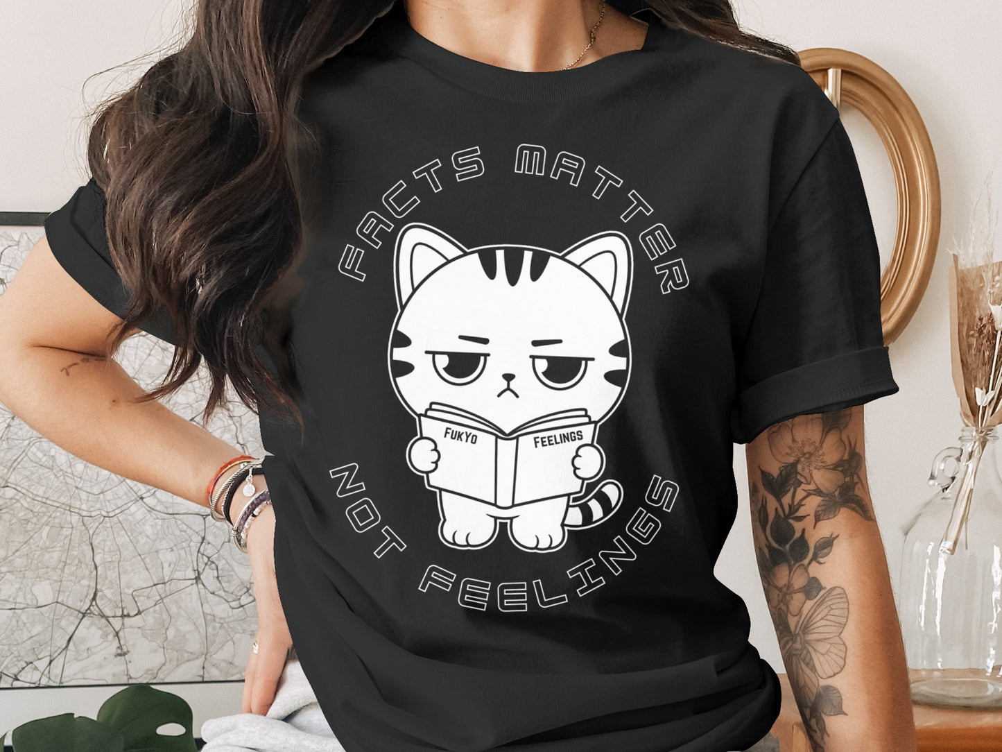 T-shirt with a graphic of a cat reading a book titled "FUKYO FEELINGS" with text "FACTS MATTER NOT FEELINGS".