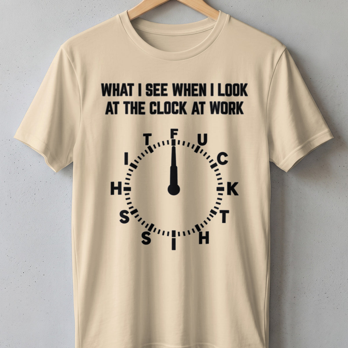 Cream t-shirt with black text: "WHAT I SEE WHEN I LOOK AT THE CLOCK AT WORK" and a clock graphic.