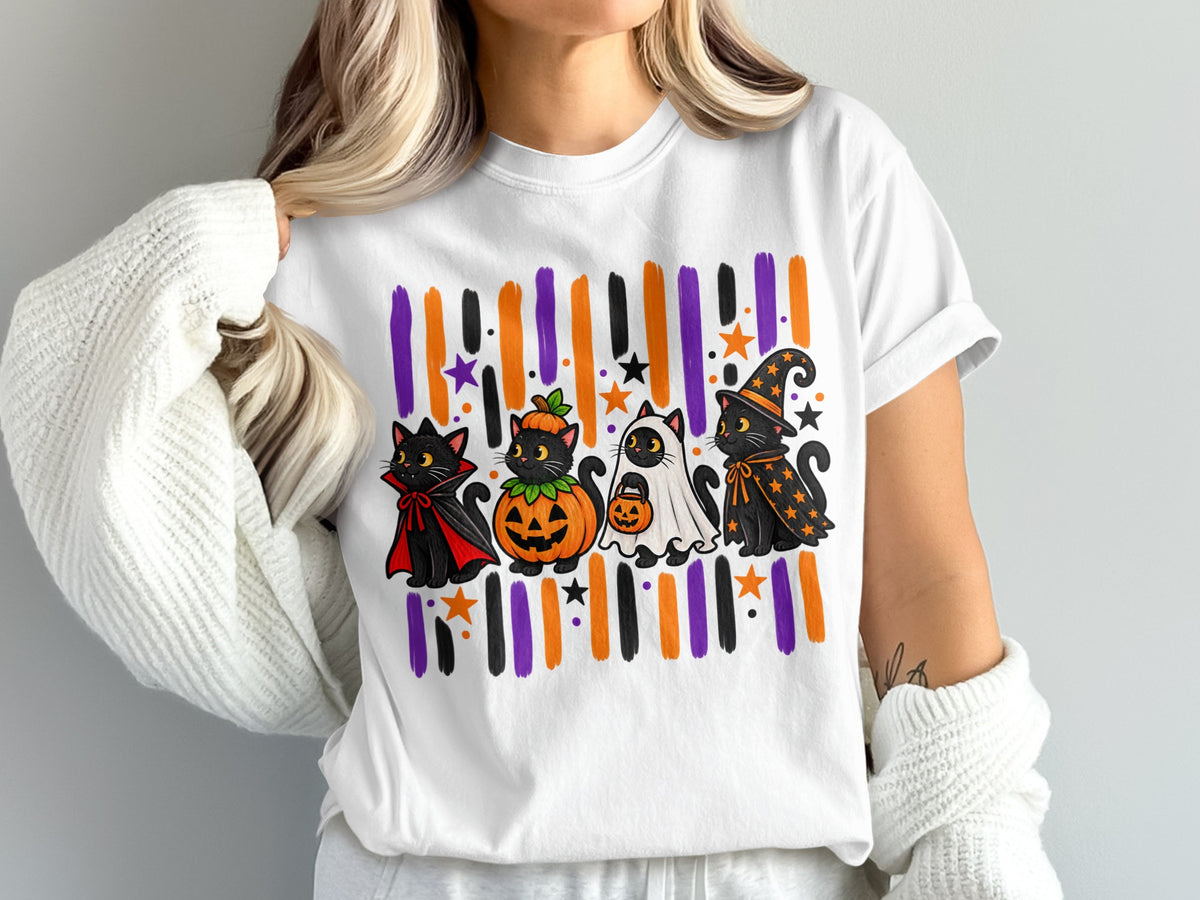 Four black cats in Halloween costumes on a white t-shirt.
