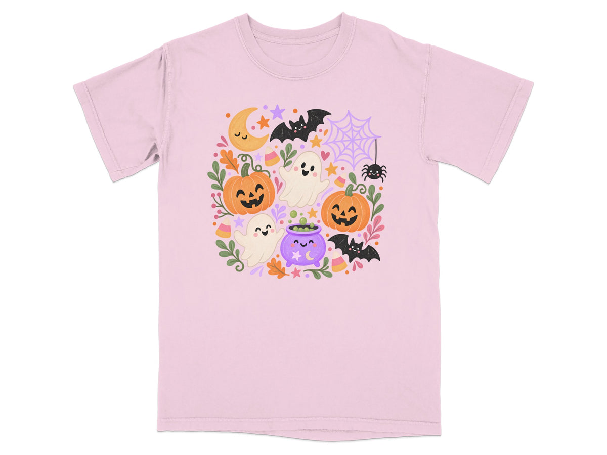 Light pink t-shirt with a Halloween-themed graphic featuring pumpkins, ghosts, bats, and a cauldron.