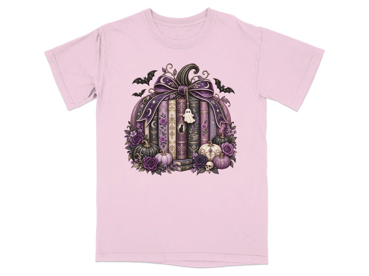 Pink t-shirt with a Halloween-themed pumpkin design featuring books and bats.