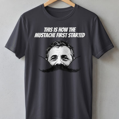 Dark t-shirt with "THIS IS HOW THE MUSTACHE FIRST STARTED" text and a man's face.