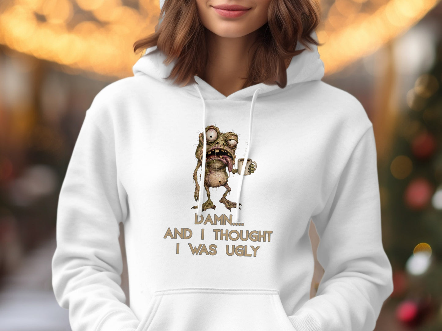 White hoodie with cartoon monster and text: "Damn.... And I thought I was ugly"