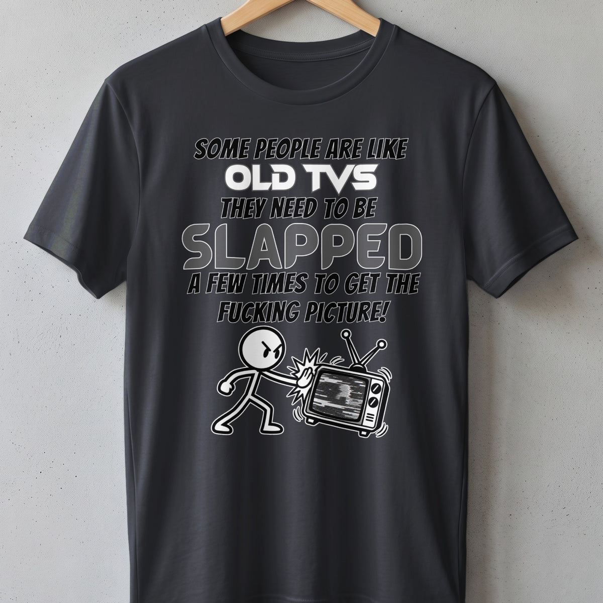 Dark gray t-shirt with white text and cartoon of person slapping an old TV.