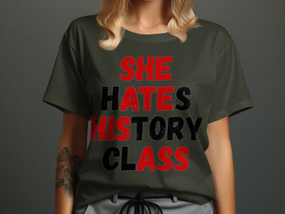 Olive green t-shirt with red and black text reading "SHE HATES HISTORY CLASS".