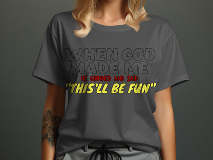 Dark gray t-shirt with text: "When God Made Me He Grinned And Said 'This'll Be Fun'"