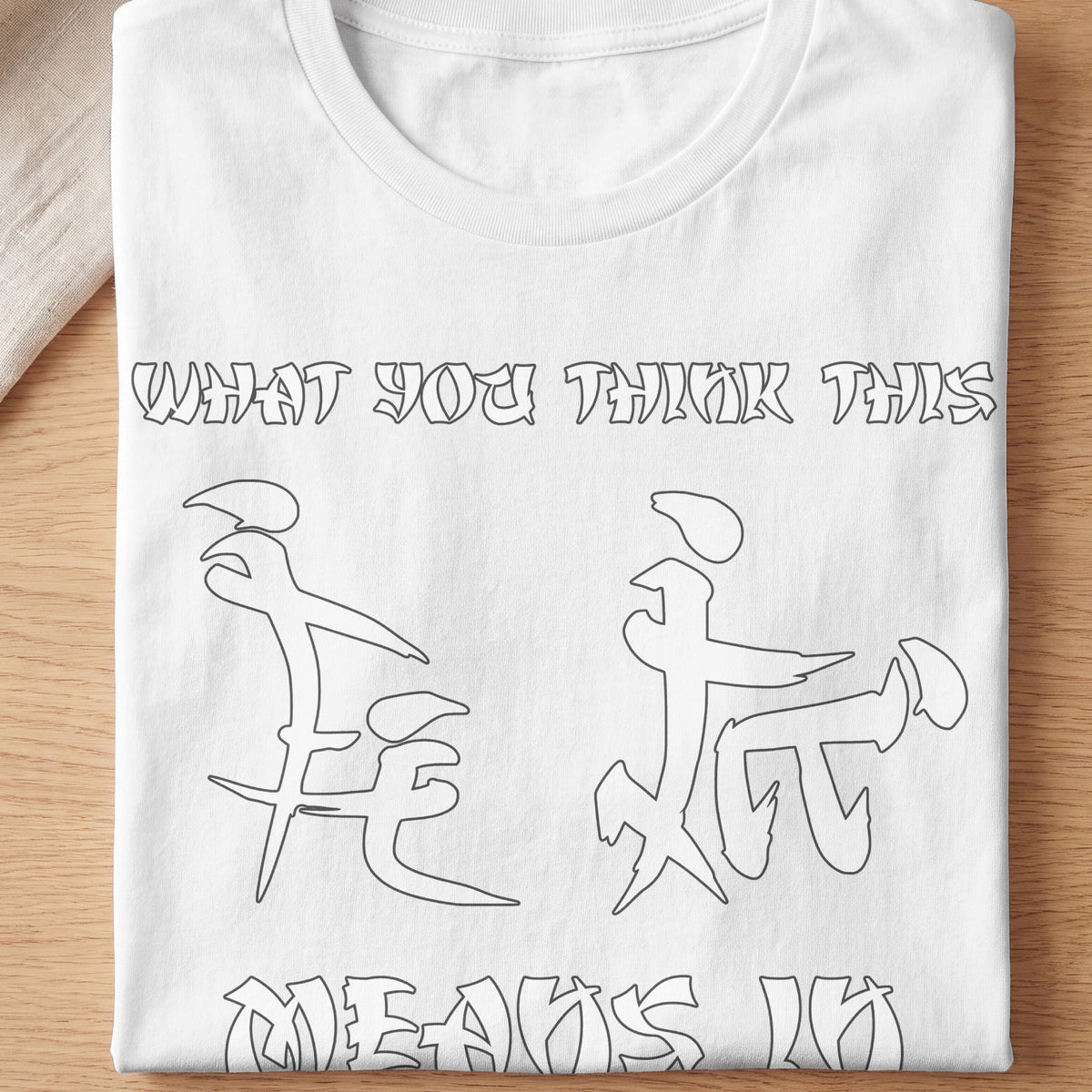 White t-shirt with text "WHAT YOU THINK THIS MEANS" and stylized graphics.
