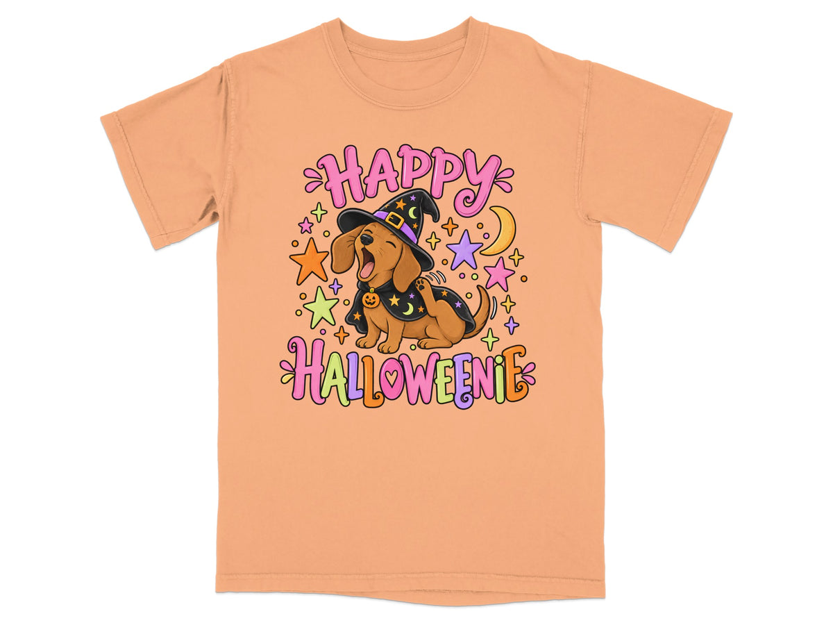 An orange t-shirt featuring a cartoon dachshund in a witch costume with the text "HAPPY HALLOWEENIE".
