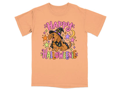 An orange t-shirt featuring a cartoon dachshund in a witch costume with the text "HAPPY HALLOWEENIE".