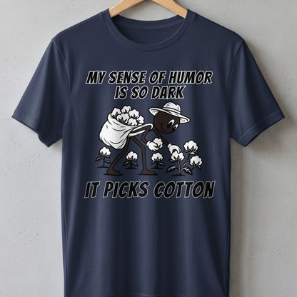 T-shirt with cartoon of person picking cotton and text "MY SENSE OF HUMOR IS SO DARK IT PICKS COTTON".