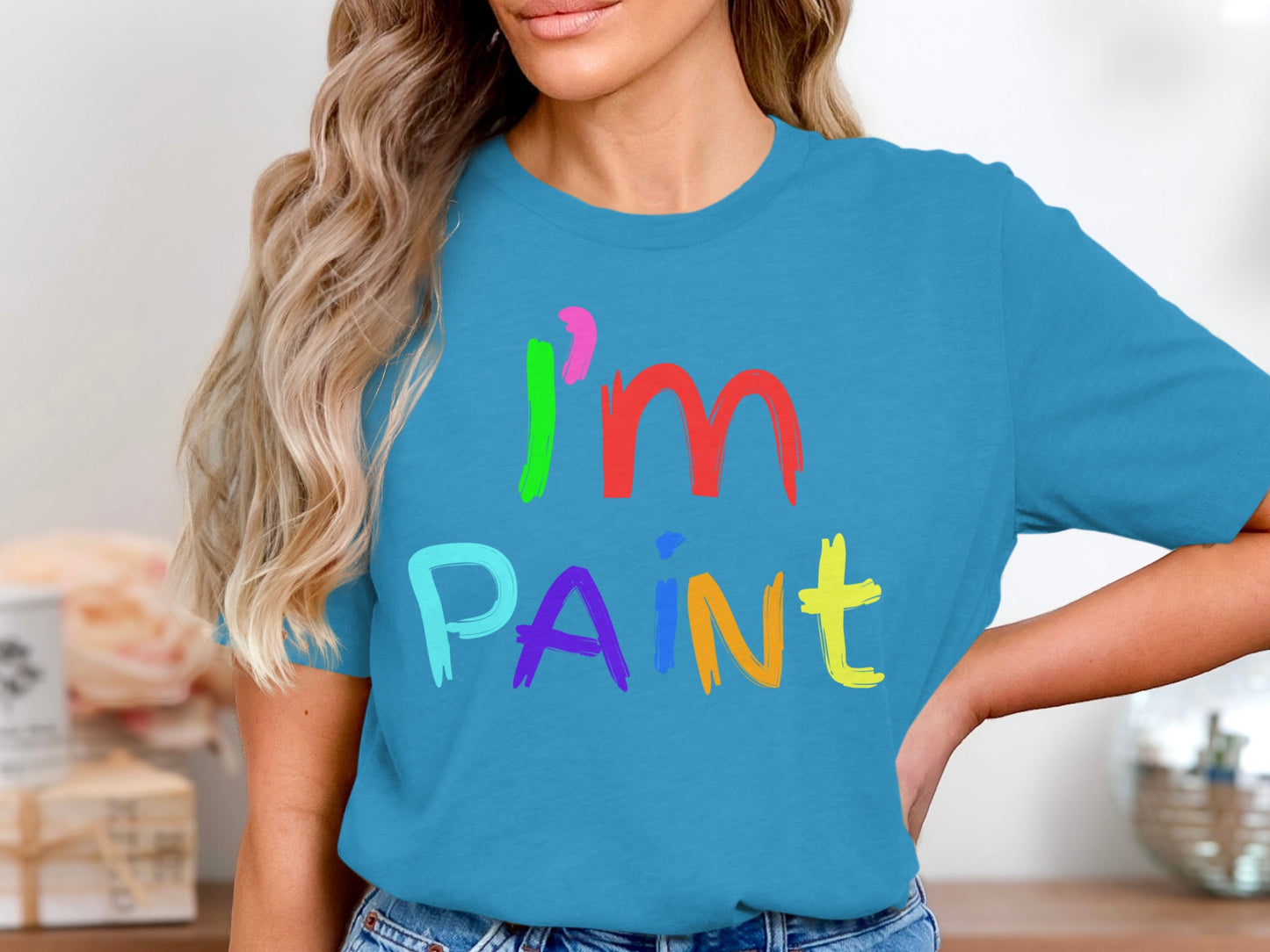 Turquoise t-shirt with colorful "I'm PAiNT" text in a brushstroke font.