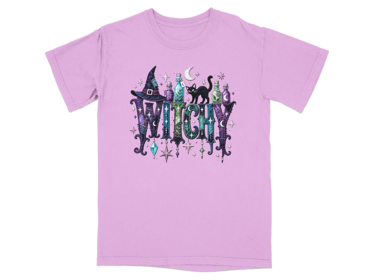 Purple t-shirt with "WITCHY" text, witch hat, potions, black cat, and stars.