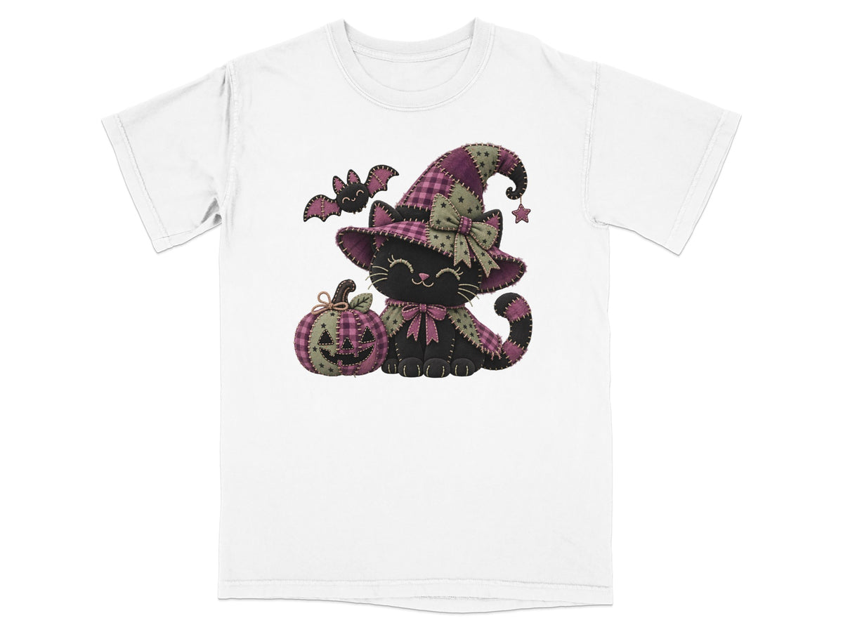 Black cat wearing a witch hat with a pumpkin and bat, on a white t-shirt.
