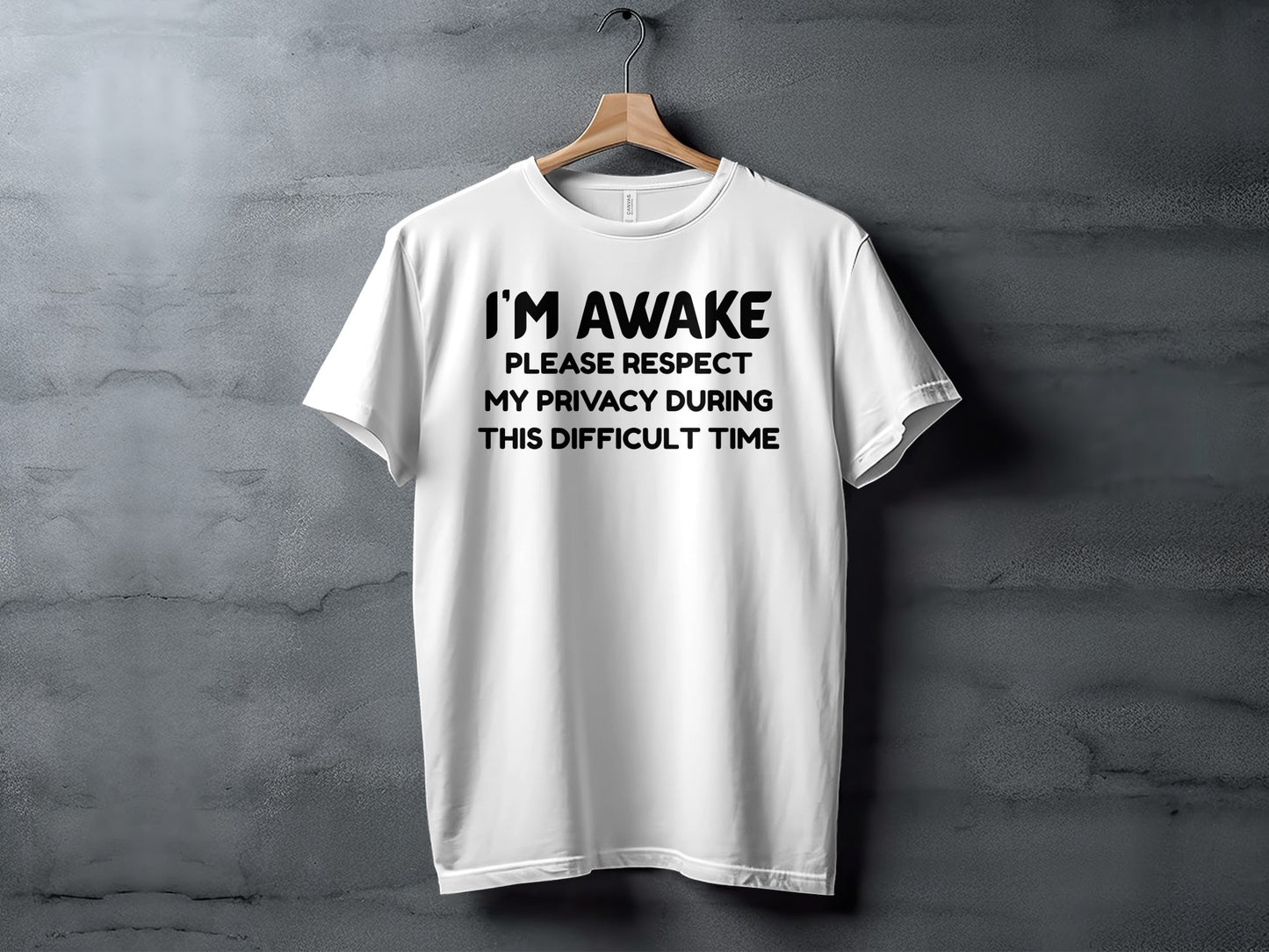 White t-shirt with black text that reads "I'M AWAKE PLEASE RESPECT MY PRIVACY DURING THIS DIFFICULT TIME".