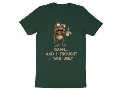 Green t-shirt with a grotesque frog character holding coffee and the text "DAMN.... AND I THOUGHT I WAS UGLY".