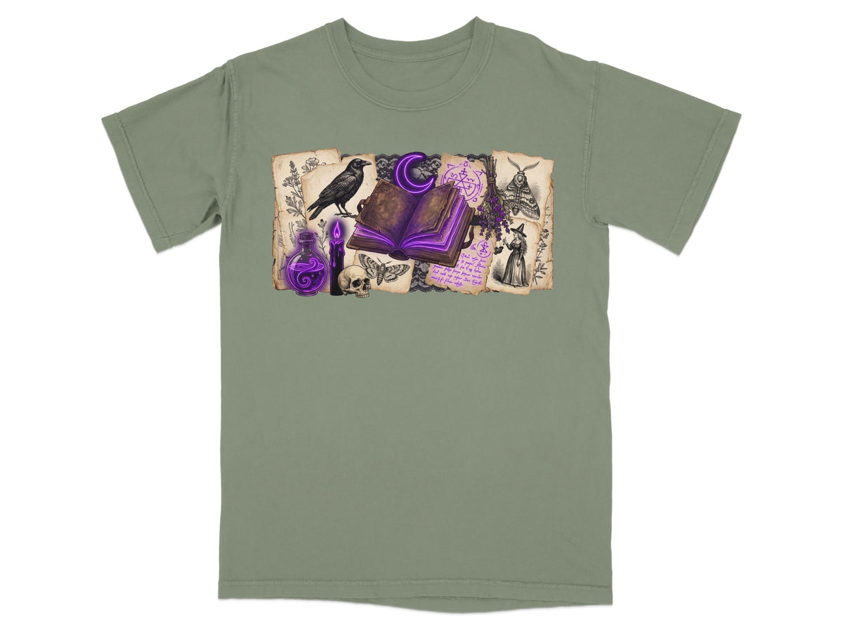 T-shirt with a gothic design featuring a raven, potion, and open spellbook.