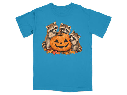 Three raccoons surround a jack-o'-lantern with autumn leaves.