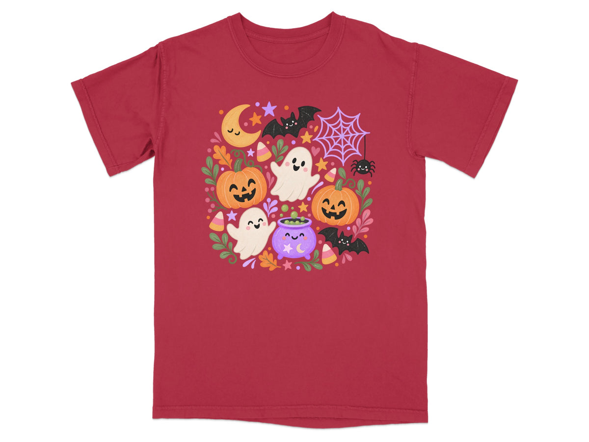 Red t-shirt with a whimsical Halloween graphic featuring ghosts, pumpkins, bats, and a cauldron.