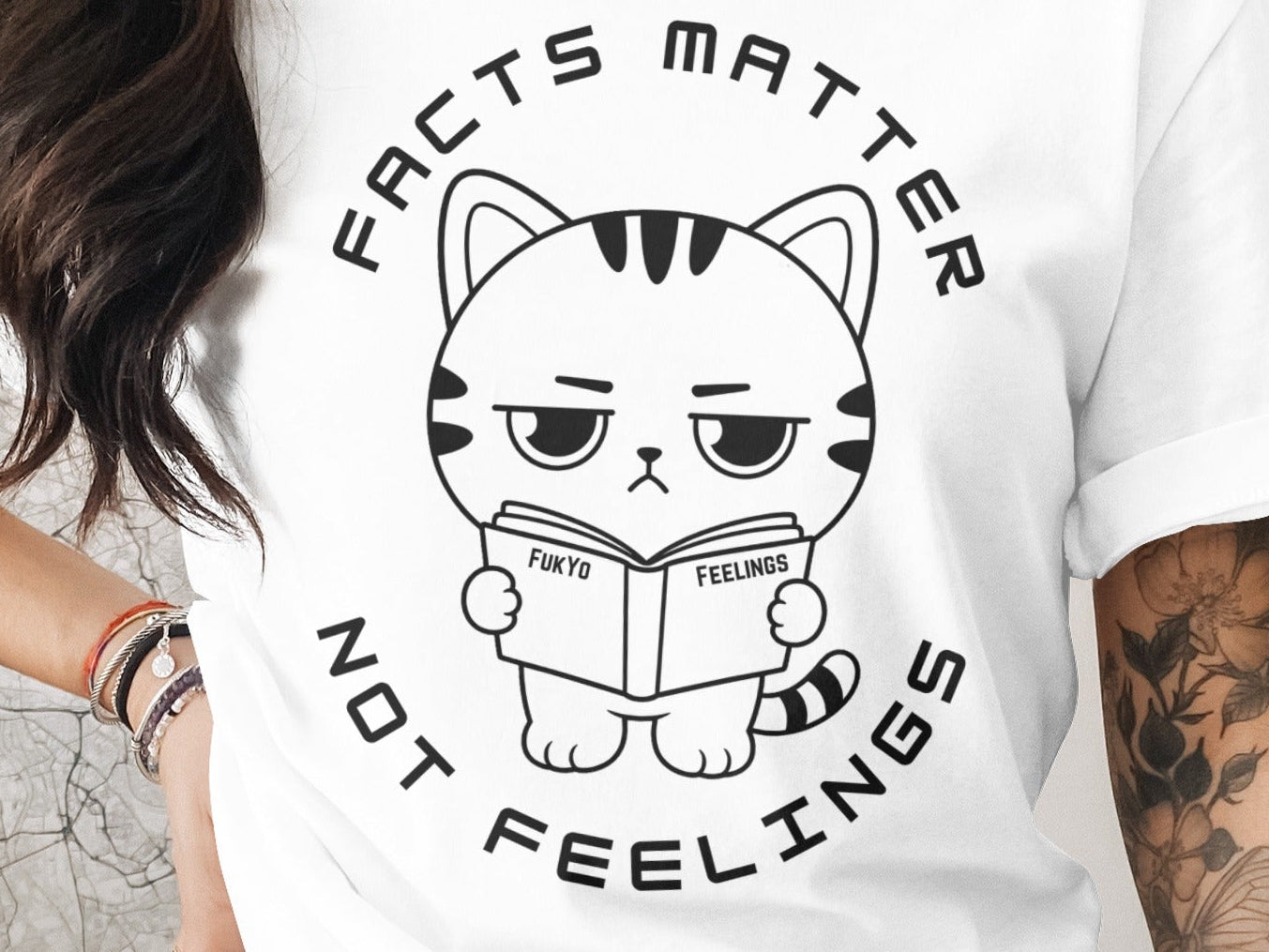 White t-shirt with a cartoon cat reading a book that says "Fukyo" and "Feelings".
