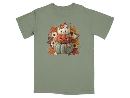 Three stacked embroidered pumpkins with flowers and autumn leaves.
