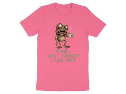 Pink t-shirt with a distressed creature holding coffee and text "Damn, and I thought I was ugly."