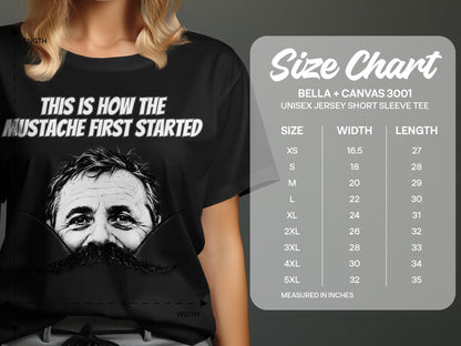 Black t-shirt with a man's face and large mustache, size chart.