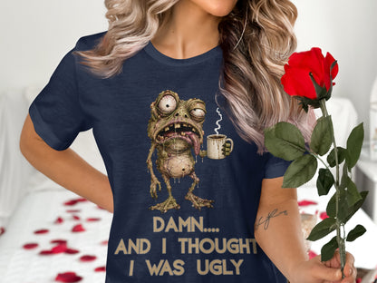 Navy t-shirt with a grotesque cartoon monster holding a coffee mug and text.