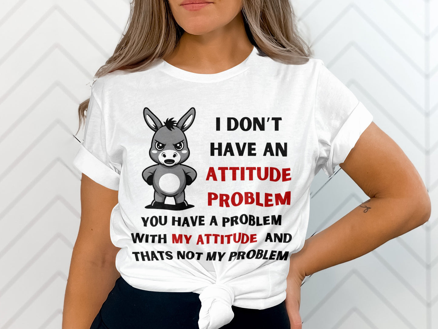 White t-shirt with donkey graphic and text about attitude problems.