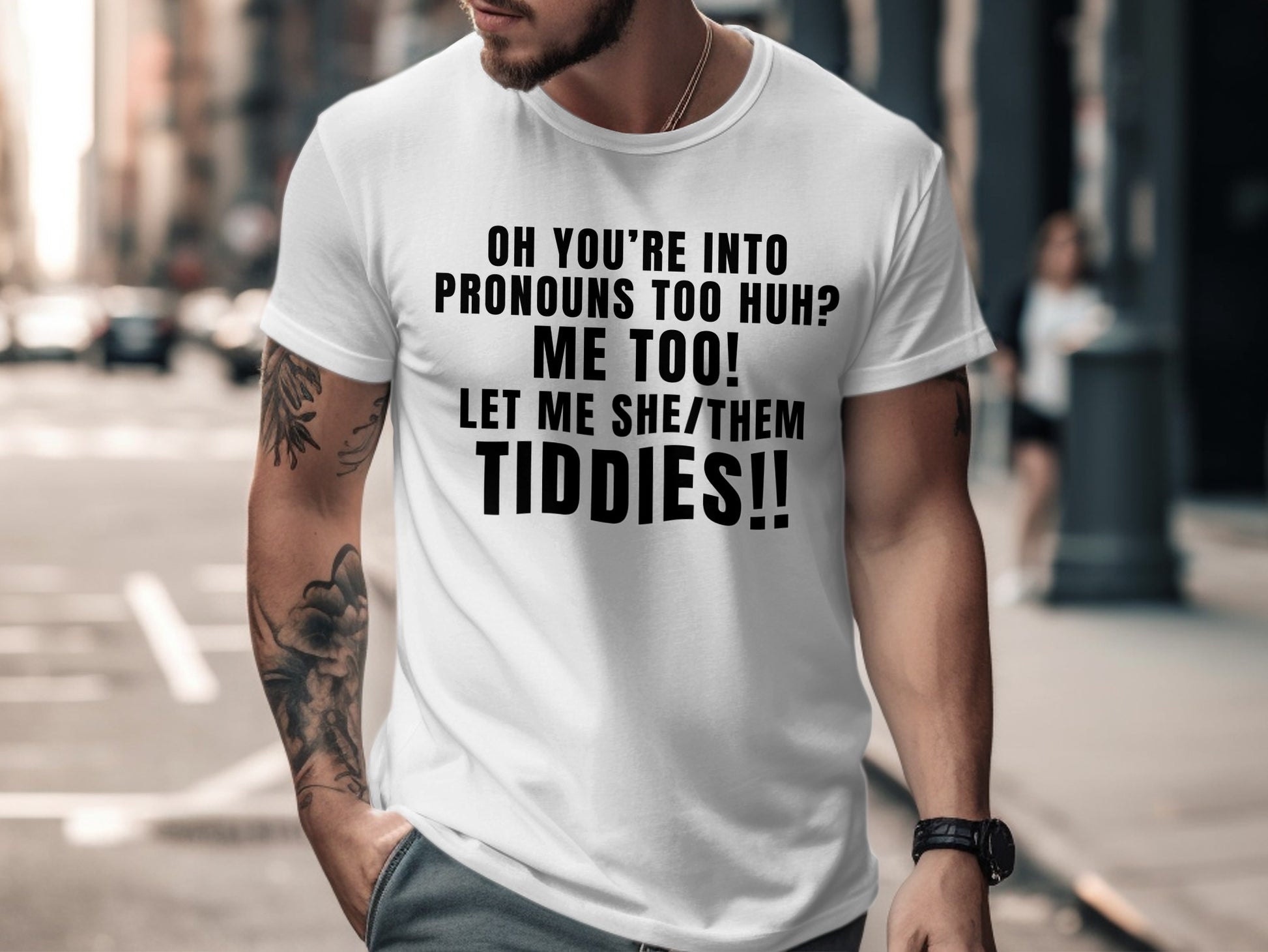 White t-shirt with black text reading "Oh you're into pronouns too huh? Me too! Let me she/them Tiddies!!".